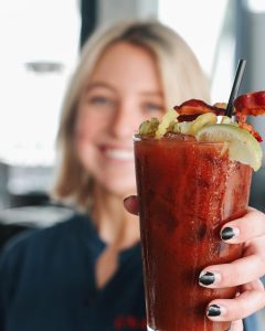 Server holding a Bloody Mary at Gnat's Landing in Statesboro